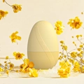 Detail of egg-shaped cream yellow aromatherapy humidifier with rippled texture and top steam vent - New Egg Shape - Yellow