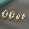 Luxury gold plated copper hoop earrings with brilliant zircon stones on dark rock background - Gold