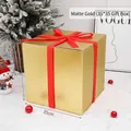 Large 35cm matte gold gift box with red ribbon for Christmas window display - 35cm Matte Gold Gift Box