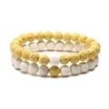 Detail of yellow and white volcanic stone beaded bracelets with natural porous texture - Yellow