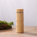 Eco-friendly bamboo shell thermos bottle with stainless steel rim on wood table - 450ml Bamboo Node Cup (Bamboo Lid)