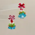 Detail of beaded Christmas tree earrings with a red bow on a transparent stand - Red Bow Tree-Padded Clip / Clip-On Earrings