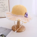 Detail of yellow knit sun hat with lace ruffle brim and purple flower accent for girls - Yellow