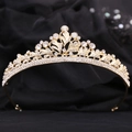 Detail of golden Baroque crown with clear rhinestones on black velvet background - Gold White Zircon