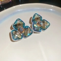 Close-up of teal diamond-set floral stud earrings on a minimalist white tray - Blue-Green Faceted Gem Starry Studs (12#)