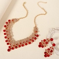 Detailed view of red rhinestone bridal necklace and earrings set with gold base finish - Red Jewelry Set