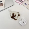Detail of plush cow print headphone case featuring soft texture and a secure snap button - White Cow Print