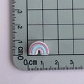 Macro shot of a mini rainbow resin accessory measuring 1.5cm on a metric scale ruler - Three-color Rainbow