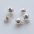 Flat lay of polished silver metal bells in various sizes with hanging loops on white background - 6mm / Silver