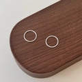 Minimalist pair of S999 sterling silver hoop earrings displayed on a dark wood tray - 990 Silver / Silver/12mm