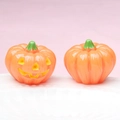 Detail of 3D luminous Halloween pumpkin figurines with Jack-O'-Lantern smile on white tray - Solid Pumpkin Color (Yellow Expression)