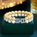Elegantes zweireihiges Perlenarmband mit gold-weißen Perlen und diamantbesetzter Schließe - Zweireihiges Perlenarmband (S0262)