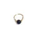 Detail of handcrafted gold wire wrapped ring featuring a deep blue sandstone bead - One Size / Blue Sandstone