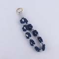 Detail of hand-woven daisy patterned keychain with navy cotton rope and gold clasp - Sapphire Blue