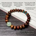 Deep brown pearwood bracelet with green jade bead and blue spacers on book background - 8mm Abacus Bead With Luminous Bead