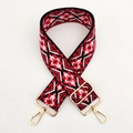 Close-up of geometric ethnic pattern woven strap with gold metal lobster clasps - Black White Red Floral