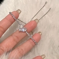 Detailed view of silver heart tennis bracelet with cubic zirconia on white fur background - Heart-Shaped Tennis Bracelet / Silver