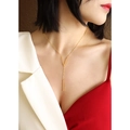 Elegant gold-plated titanium steel V-shape long pendant necklace on a female model - Gold