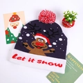 Detail showing the 'Let it snow' text on a purple reindeer knit Christmas beanie with LED - Dark Blue Reindeer