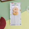 Yellow number 8 dinosaur themed birthday candle with orange spots on a white stick - Orange Dinosaur Number 8
