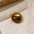 Macro shot of an amber resin dome ring with tortoiseshell patterns on beige linen fabric - 35# Ring - Coffee - Tortoise Resin