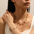 Elegant gold stainless steel jewelry set with round bead pendants worn by a female model - Gold Steel Ball Jewelry Set (Necklace+Bracelet+Earrings)
