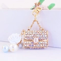 Golden camellia bag keychain featuring colorful rhinestones and white rose charm - Individual Packaging / AB White