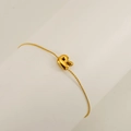 Golden bubble letter R pendant on a thin stainless steel chain bracelet for women - Letter R