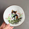 Ceramic storage bowl with calico cat and red berries pattern on a white interior - Cat Pattern