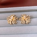 Detailed macro view of vintage golden firework earrings with inlaid sparkling zircon stones - Gold (Silver Earring Post)