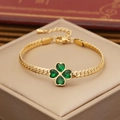 Golden clover bracelet with emerald heart stones on beige jewelry box display - 2# Bracelet
