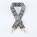 Detail of adjustable black and white geometric embroidery bag strap with gold metal clips - Light Gold Buckle / Black & White