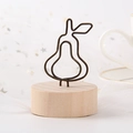 Pear-shaped black wire memo holder with a round wooden base for home decor - Pear