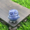 3.5cm natural blue quartz crystal owl figurine displayed on a wooden stand in a garden - Blue Aventurine