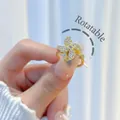 Adjustable rotating gold-plated flower ring with shimmering white cubic zirconia stones - Rhinestone Windmill Rotatable Style (H006)