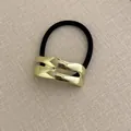 Black high-elastic hair tie with an irregular golden wavy metal decorative charm - Small Lip Shape Gold
