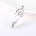 White marble hexagonal prism pendant with silver metallic clasp on a clean white tray - Howlite