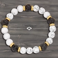 Elastic bead bracelet with white turquoise, black lava stone, and golden metal spacers - Dream