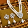 Close-up of double-layer pearl necklace and teardrop earrings on green velvet pad - Double Layer Pearl Style / Silver White Two-piece Set