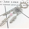 Silver metal dreamcatcher keychain with pink bead and feather charms on white background - Style B Pink