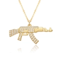 Macro shot of gold-plated AK-47 pendant with white zircons on a white background - AK-47 Rifle Shape Style (h234)
