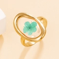 Golden oval stainless steel ring featuring a real green dried flower in clear resin - Gold with Lake Blue Flower