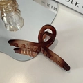 Elegant translucent dark coffee hair claw clip with cross twist design on a white desk - Matte Tortoise-13cm