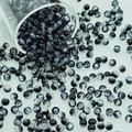 Detailed view of 6mm black and white marble crackle glass beads flowing from a container - 6mm / Black