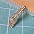 Elegant gold feather hair clip encrusted with sparkling crystals for a trendy look - Gold Feather Duckbill Clip