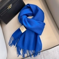 Blue 100% Australian wool scarf with tassel edges on a beige leather seat background - Sapphire Blue