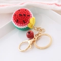 Handmade crochet watermelon keychain with red bell and gold metal ring on ceramic tray - Fruit Style-Watermelon