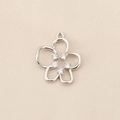 Detail of silver flower pendant with five clear round gemstones on beige fabric background - PJ0193-Silver Small Flower Zirconia
