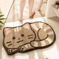 Brown and beige striped cat shaped absorbent bathroom mat on light wood floor - Squatting Cat