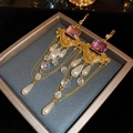 Detail of vintage French palace earrings with purple gems and pearls in a jewelry box - Gold-Purple